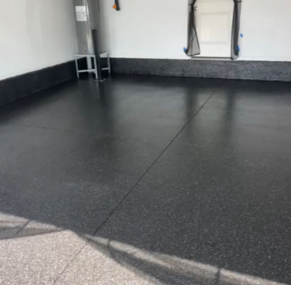 Stunning residential garage with gray flake epoxy system